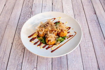 Japanese recipe for octopus takoyaki with soy sauce and dried tuna slices, Katsuobushi