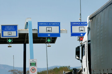Toll signs on the highway, written in Portuguese, Brazil.