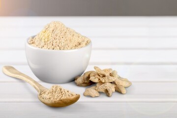 Fingerroot with finger root herbal powder in ceramic mortar on the desk