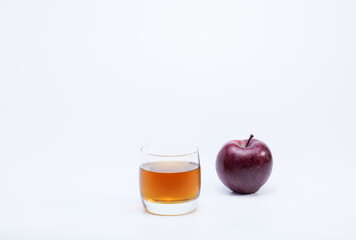 Red apple and glass of apples juice