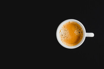 Cup of hot coffee on dark background. Flat lay, top view, copy space
