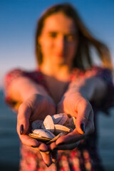 person holding a snail shells