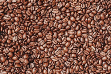 Closeup of roasted black coffee beans. Flat lay. Top view. Food background, texture