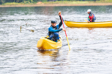 A solo canoeist practices stroke techniques on a rainy fall day as part of a &ldquo;moving water&rdquo; paddling course. Shot on the Madawaska River an iconic paddling destination in Eastern Ontario, Canada.