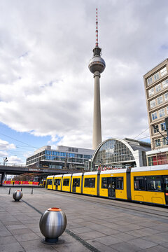 Berlin, Germany - 21.03.2021:  view on theTV Tower  in Berlin and  on the Alexander Square and a the yellow train,  a tourist attraction and meeting place