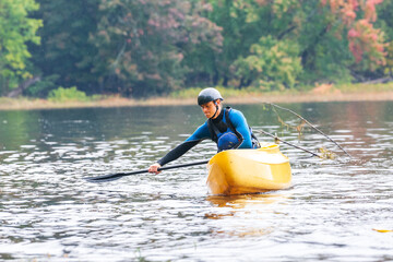 A solo canoeist practices stroke techniques on a rainy fall day as part of a &ldquo;moving water&rdquo; paddling course. Shot on the Madawaska River an iconic paddling destination in Eastern Ontario, Canada.