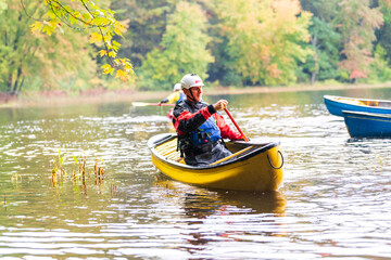 A solo canoeist practices stroke techniques on a rainy fall day as part of a “moving water”...