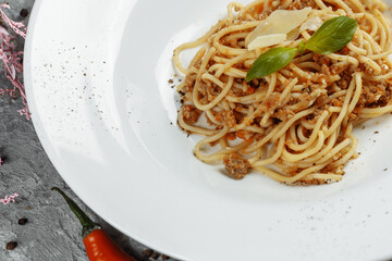 Spaghetti pasta with bolognese sauce and parmesan cheese, top view