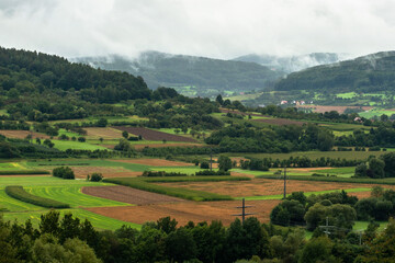 Fototapeta na wymiar View of mountains and fields in Franconian Switzerland near Ebermannstadt in the fog