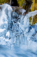 Naklejka na ściany i meble Beautiful mountain river in winter with icicles