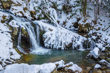 Obraz premium Beautiful mountain river waterfall in winter