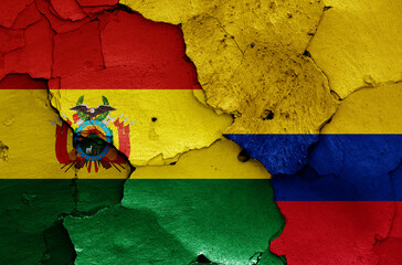 flags of Bolivia and Colombia painted on cracked wall