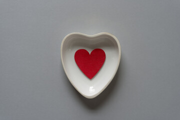 isolated heart shaped dish on gray