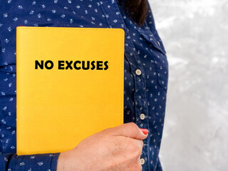  NO EXCUSES phrase on the piece of paper.