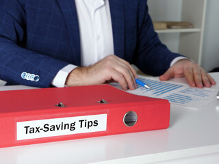  Tax-Saving Tips phrase on the folder for documents.