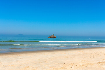 Fototapeta premium A beautiful sunny day at Juquehy beach views the island of stones.