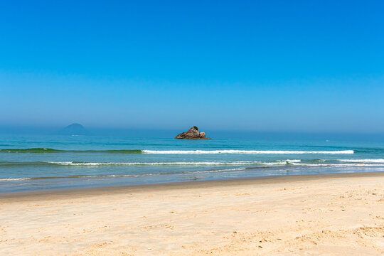 A beautiful sunny day at Juquehy beach views the island of stones.
