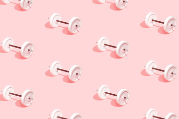 Minimal abstract pattern made of  white dumbbells and pencil with eraser isolated on pastel pink background. Writing and drawing school exercises concept. Sun and shadows. Learning supplies texture.