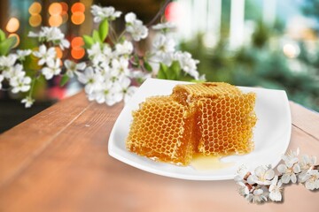 Sweet honey jar surrounded spring flowers blossoms.