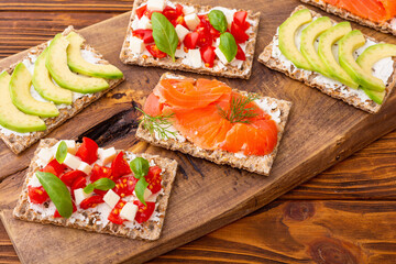 Crispbread with  salmon avocado mozzarella  and tomatoes