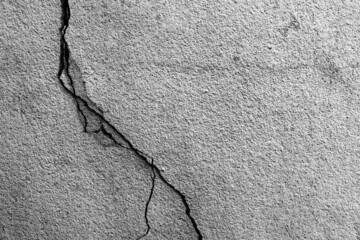Grunge concrete cement wall with crack in industrial building