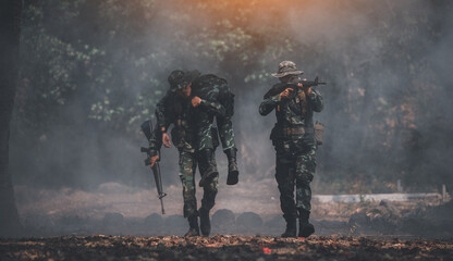 Naklejka premium Soldiers help to carrying friend after have attraction and soldier have injury go to hospital.