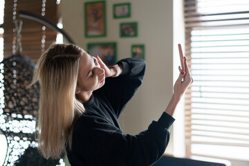 young woman making a self portrait to upload photo to social network