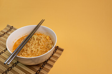 Instant noodles cooked in bowls and with chopsticks are ready to eat as a main dish or as an appetizer.