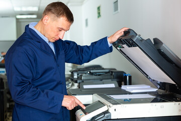 Service engineer using a copy machine. High quality photo