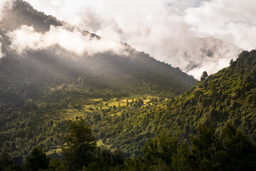 hills of the junta valley illuminated by the sun's rays filtering through the clouds 