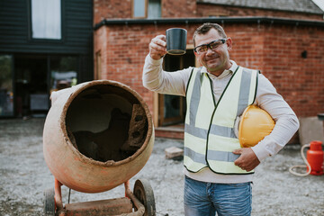 Contractor take a break next to a cement mixer