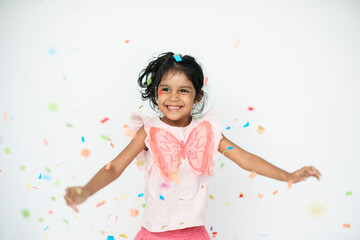 Obraz na płótnie Canvas Cute girl dancing in confetti
