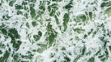 The sea waves that are hitting the shore Taken from a high angle with a drone
