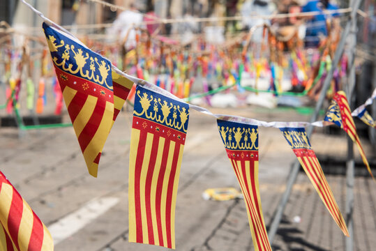 Flags of Valencia with firecrackers in the background ready for the "mascletá".