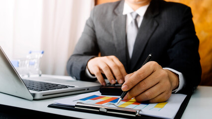 businesswoman hand working with laptop computer, tablet and smart phone in modern office with virtual icon diagram at modernoffice in morning light