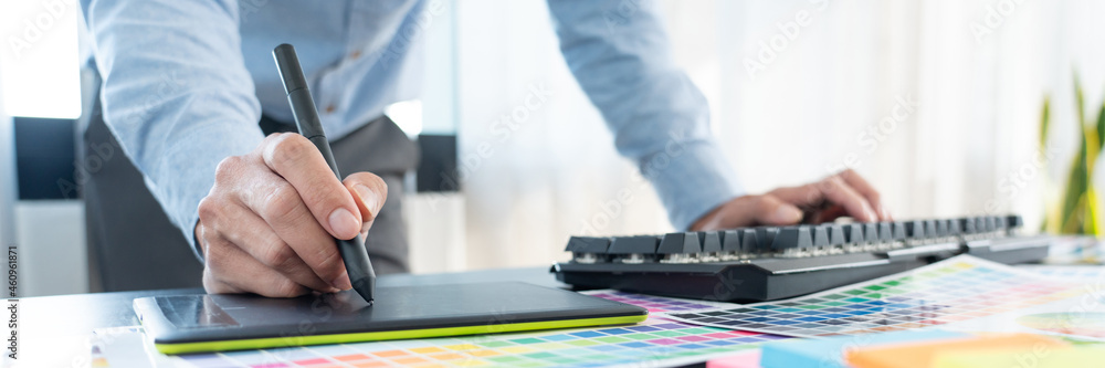 Poster creative graphic designer choosing color scale for editing artwork while working in office.