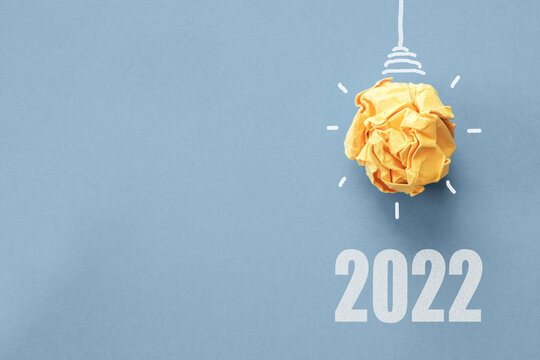 2022 Yellow Paper Light Bulb On Blue Background, Innovative Business Vision And Resolution Goal Concept