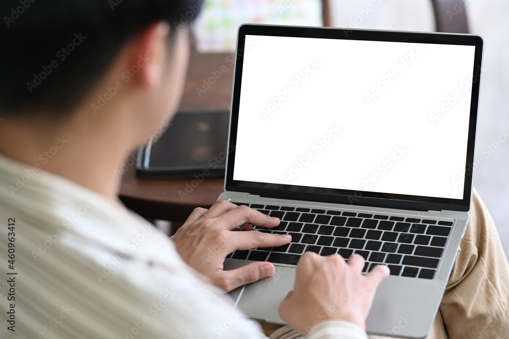 Poster back view of businessman using laptop computer.