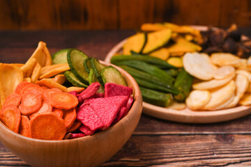 Homemade vegetable chips on wooden tray. Organic diet and vegan food.