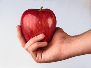 human hand with red apple
