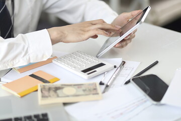 Businessman using digital tablet on desk