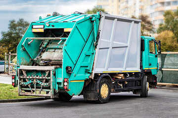 A garbage truck picks up garbage in a residential area. Separate collection and disposal of...