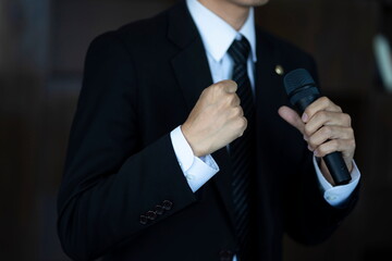 Close up of businessman speaking with microphone 