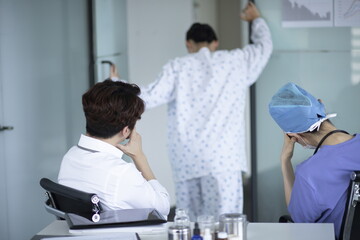 Doctor checking patient's pain in office