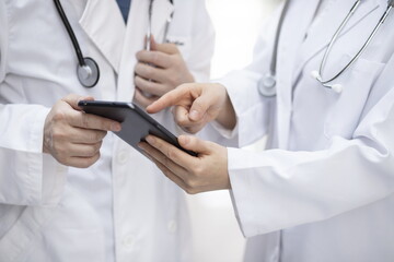 Doctors reviewing medical records with digital tablet	