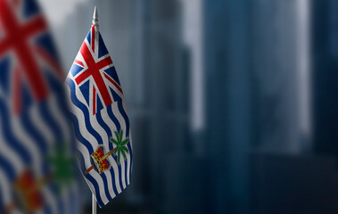 Small flags of British Indian Ocean Territory on a blurry background of the city