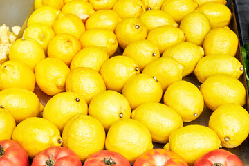 Yellow lemons on a stall in a store for sale on the street. Food concept