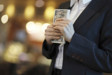 Businesswoman holding bundle of cash