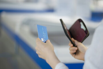 Woman shopping with credit card in supermarket