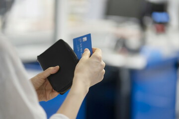Woman shopping with credit card in mart